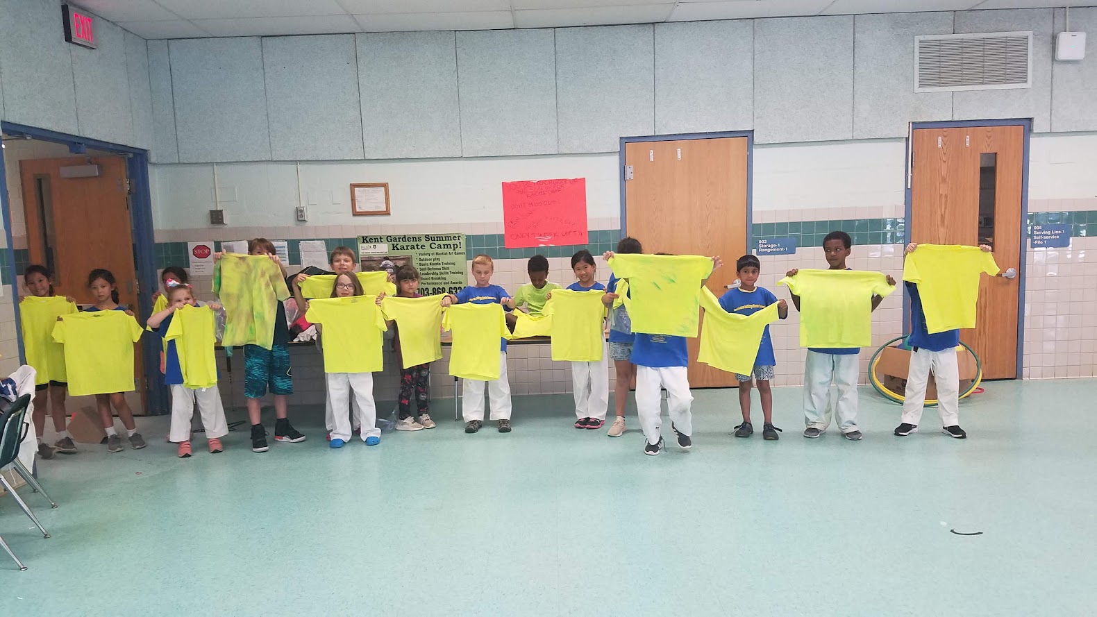 Kids holding neon yellow t-shirts
