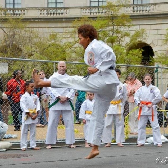 Instructor flying kick outdoor demonstration