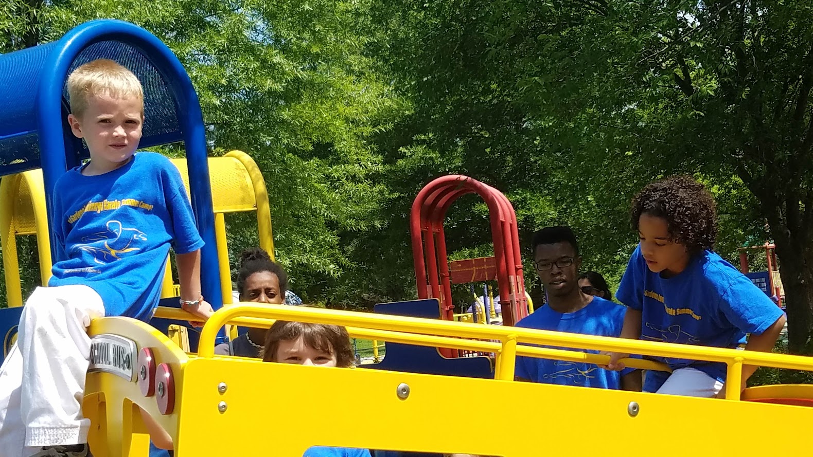 Kids on yellow playground bus