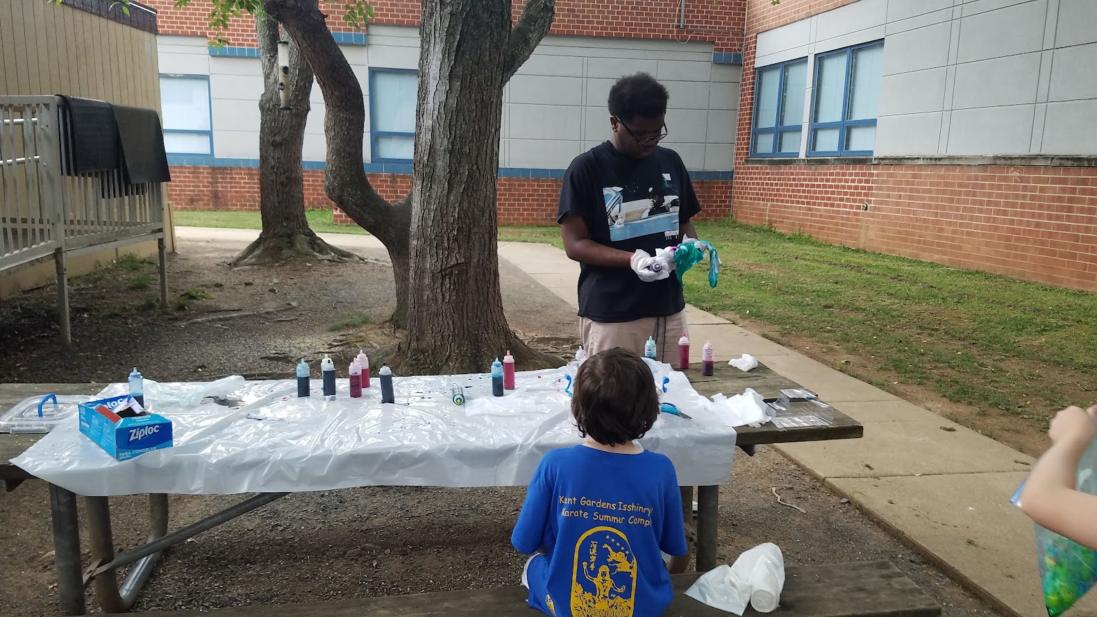 Tie-dye station setup with dye bottles