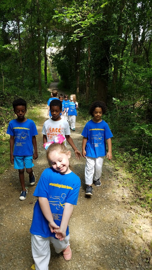 Smiling girl leading nature hike