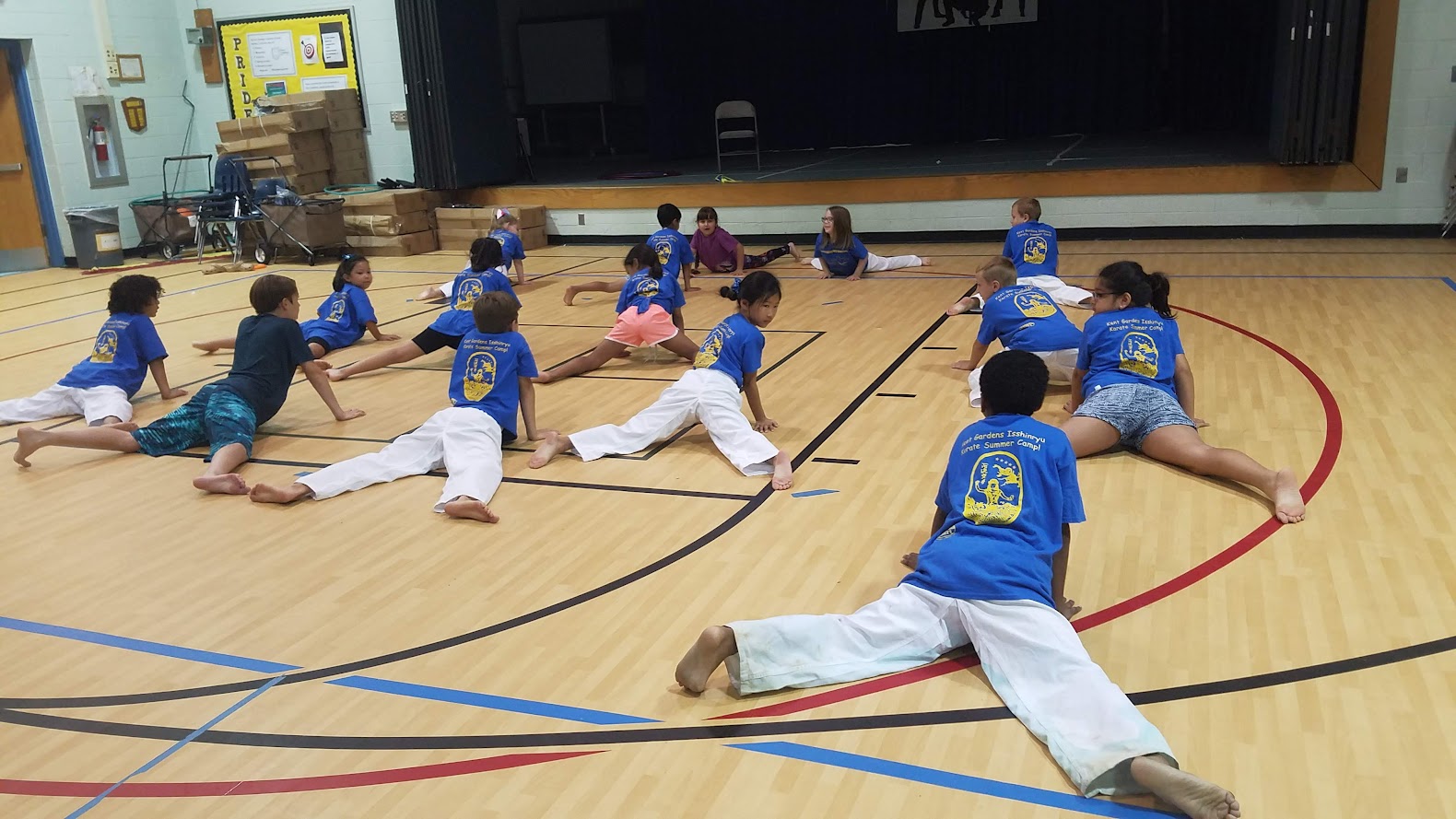 Kids doing splits stretching in gym